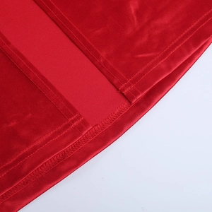 Detailed macro view of the slit hem and double stitching on a red satin evening dress