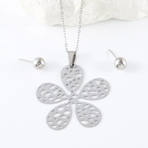 Close-up of silver hollow five-petal flower pendant necklace and stud earrings set