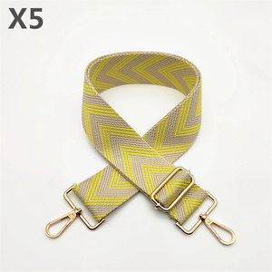 Detail of adjustable beige and yellow herringbone fabric strap with gold metal buckles