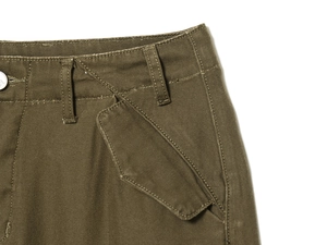 Detailed close-up of army green cargo pants showing heavy twill texture and belt loops