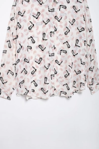 Close-up of pink paisley and black abstract print on chic long sleeve button-up shirt