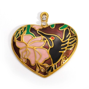 Detail of a 18k gold heart pendant with enamel hummingbird and sparkling rhinestone charms