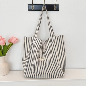 Detail of striped canvas tote bag with side pocket and today feel the warmth text