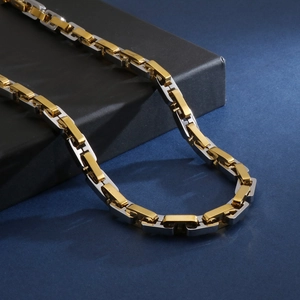 Close-up of two-tone gold and silver square link chain necklace for men in punk style