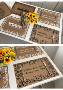 Detailed view of brown linen-style placemats with vintage silk-screened floral patterns