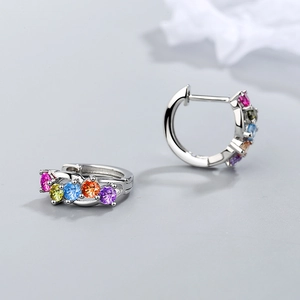 Silver hoop earrings featuring five colorful rainbow gemstones in a minimalist design