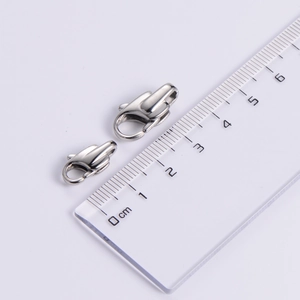 Polished stainless steel lobster claw clasps shown with a scale ruler for size reference