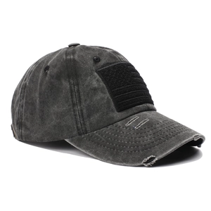 Detail of vintage grey washed cotton baseball cap featuring worn brim and velcro patch