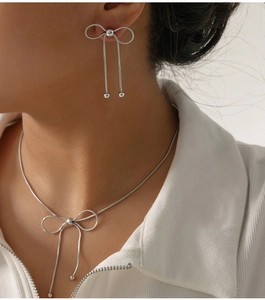 Close-up of a silver butterfly jewelry set featuring long tassel earrings and necklace