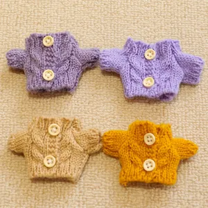 Miniature cable knit sweaters in four colors with tiny buttons for plush dolls