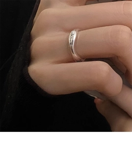 Macro shot of S925 sterling silver smile ring with irregular wave design and engraving