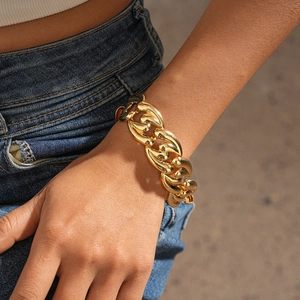 Close-up of a chunky gold link chain necklace worn on neck for a bold fashion look