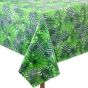 Close-up of tropical green monstera and palm leaf pattern on a waterproof party tablecloth