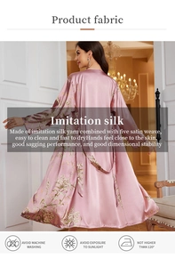 Detail of light pink floral satin robe showing silky fabric texture and elegant flower pattern