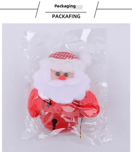 Detail of Santa Claus metal bell ornament in transparent packaging for Christmas tree decoration