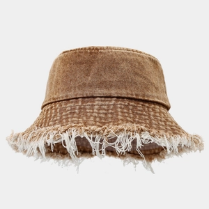 Detail of frayed fringe edges on brown washed denim wide brim bucket hat for women