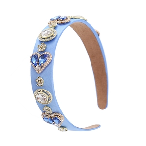 Detailed view of light blue baroque headband with crystals and golden floral accents