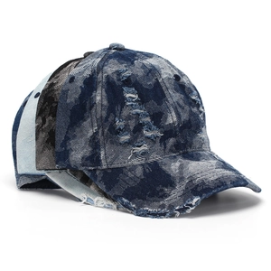 Close-up of distressed denim baseball cap with patchwork design and ripped details