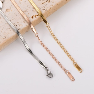 Detailed view of tricolor snake bone chains with lobster clasp and extension links
