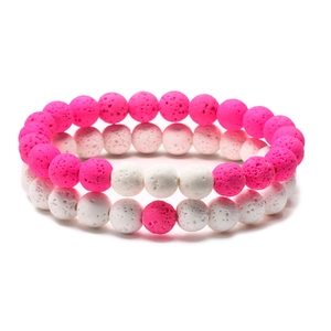 Lava stone couple bracelets set with pink and white porous natural beads on white background