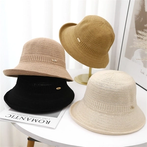 Women's hollow knit bucket hat in four colors with a small golden metal side tag