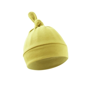 Detailed view of soft yellow cotton newborn knot hat with high quality ribbed fabric texture