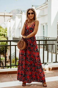 Outdoor shot of a red floral V-neck sleeveless bohemian maxi dress with flowing fabric