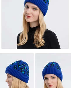 Detail view of royal blue knit beanie with leopard pattern and cozy ribbed edge design