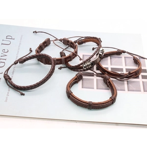 Set of five vintage brown leather bracelets featuring braided designs and metal accents