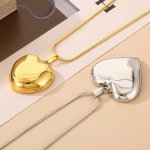 Polished hollow heart pendant necklaces in gold and silver with elegant snake chains