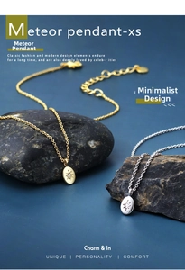 Macro detail of gold and silver meteor pendant necklaces featuring engraved star patterns