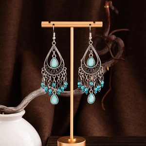 Boucles d'oreilles bohèmes plumes de paon vintage avec pompons argentés et turquoise