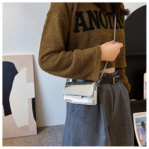Silver crocodile texture mini chain bag worn as a stylish shoulder crossbody bag