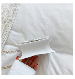 Detail view of the compact side structure and golden chain of the white silicone bag
