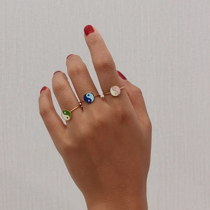Detailed view of 18K gold-plated adjustable rings with colorful Tai Chi enamel charms