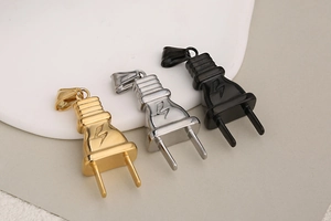 Three hiphop stainless steel plug pendants in gold, silver, and black with lightning bolt