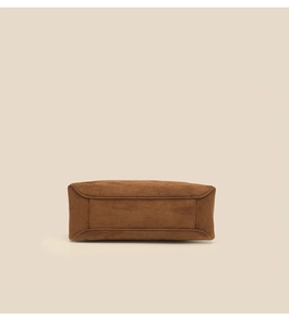 Detailed bottom view of brown suede bowling bag showing premium texture and neat stitching