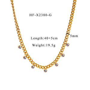 Detail view of gold Cuban link necklace with sparkling circular cubic zirconia pendants