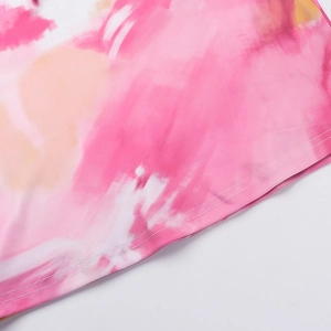 Detailed macro view of pink floral watercolor print with double-needle hem stitching