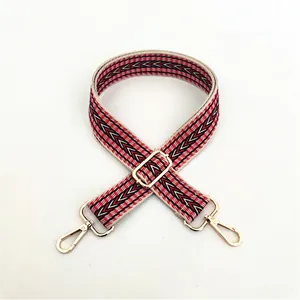 Detail of red and black geometric ethnic woven bag strap with gold metal lobster clasps
