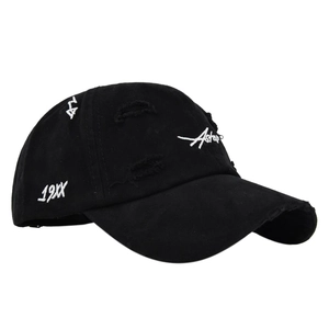 Detailed view of black distressed baseball cap with white 3D embroidery and torn fabric edges