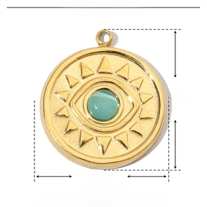 Macro detail of a 19x17mm gold stainless steel sun eye pendant with green natural stone