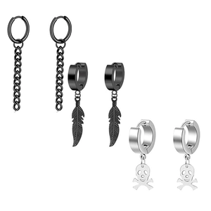 Detailed view of three pairs of black and silver dangling earrings with feather and skull