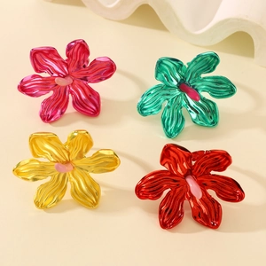 Macro detail of vibrant oversized floral rings with metallic petals and pink centers