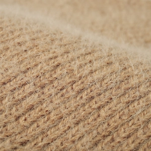 Close-up of thick camel knit beanie with soft plush texture and premium yarn weave