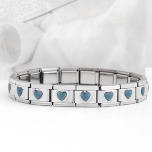 Macro view of stainless steel Italian charm bracelet with a blue heart module