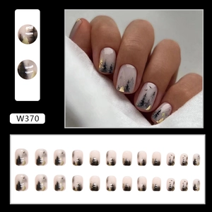 Ink painting style press on nails with gold foil accents and black tree silhouettes