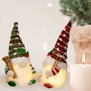 Set of two glowing Christmas gnomes with knit hats and warm lights for holiday home decor