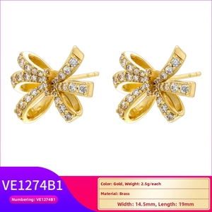 Detail of bowknot stud earrings showing brass material with zircons and 14.5x19mm size
