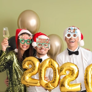 Close-up of three festive Christmas party glasses with Merry Christmas glitter accents